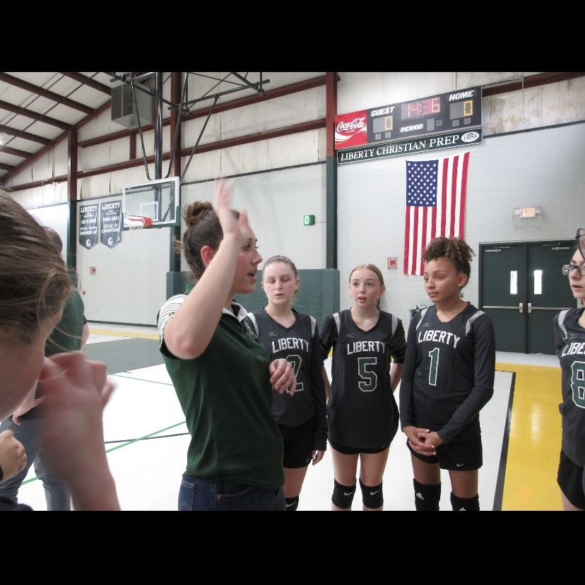 Varity Volleyball in a timeout during their home game.