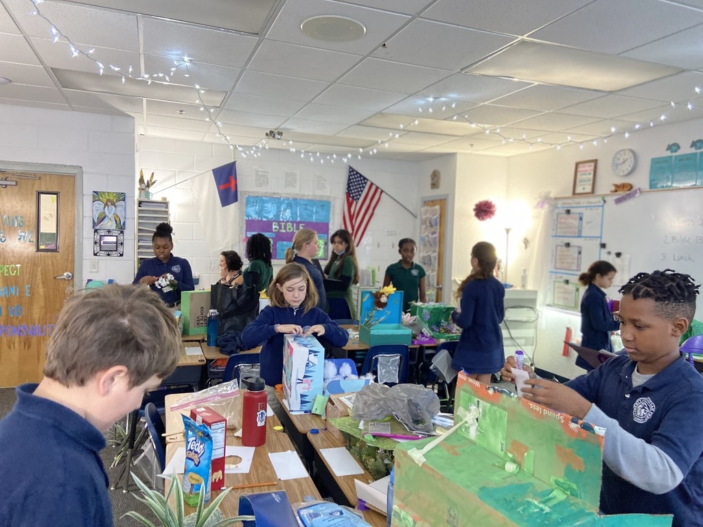 5th graders putting the finishing touches on their biome projects.